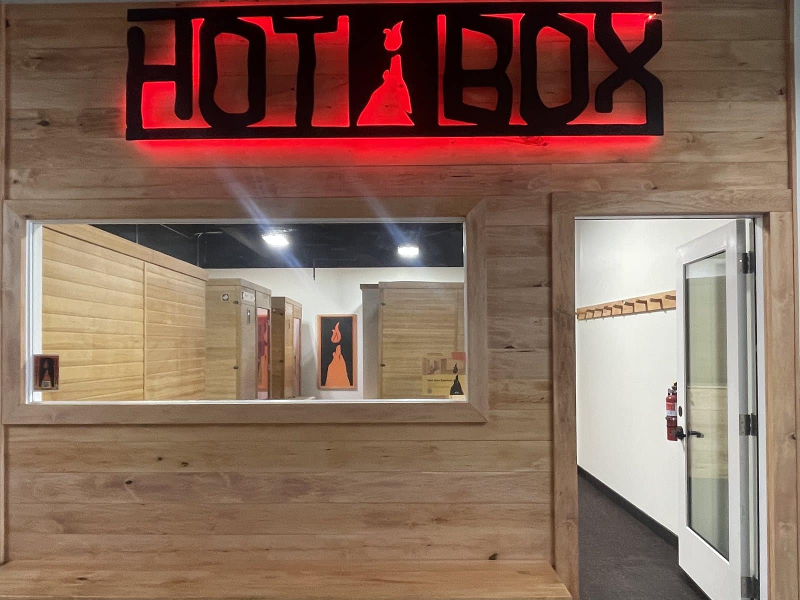 Hot Box entrance with the lit Hot Box sign above the front window