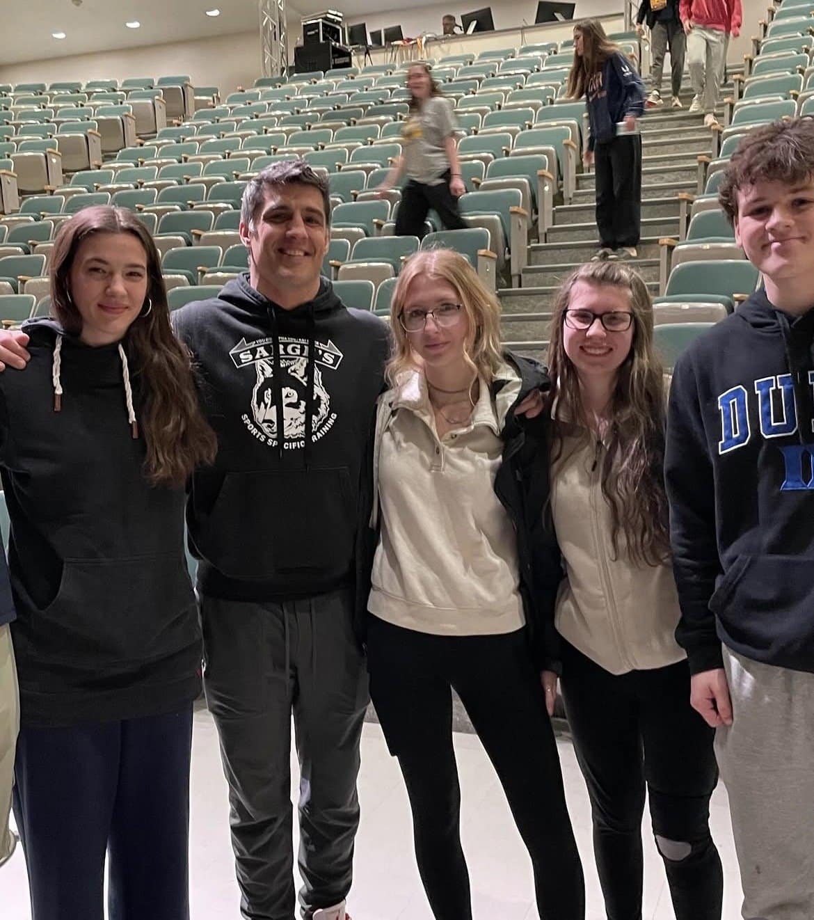 Chris Sargent with high school students in an auditorium after a sleep presentation